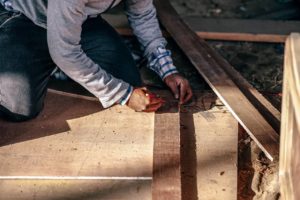 handyman measuring cuts for carpentry project